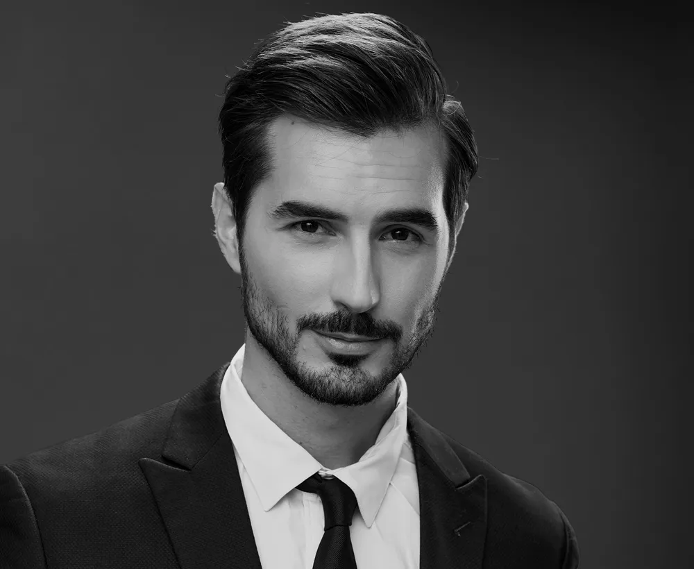 man-in-suit-posing-on-grey-background-2026-03-20-06-02-10-utc-re
